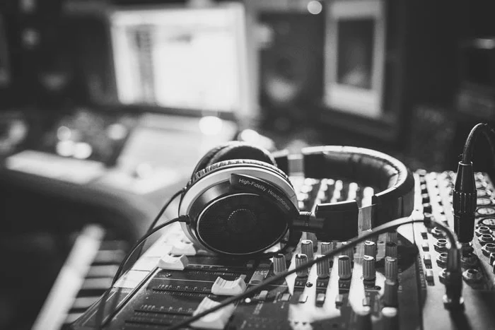 black and white image of headphones on a sound board